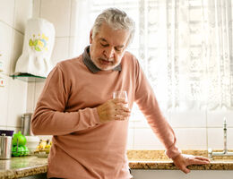 A man leans on a kitchen counter.
